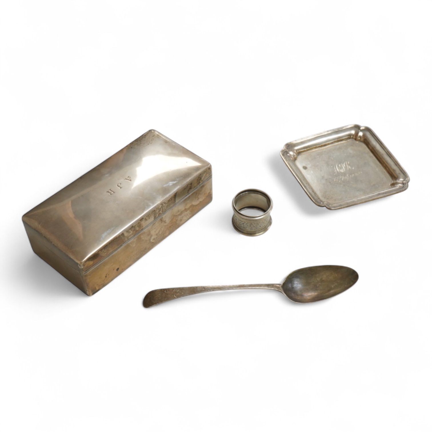 A George VI silver mounted rectangular cigarette box, Atkin Brothers, London, 1944, 17.3cm, together with a small silver dish, William Comyns & Sons Ltd, London, 1945, an Edwardian silver napkin ring and a George III sil